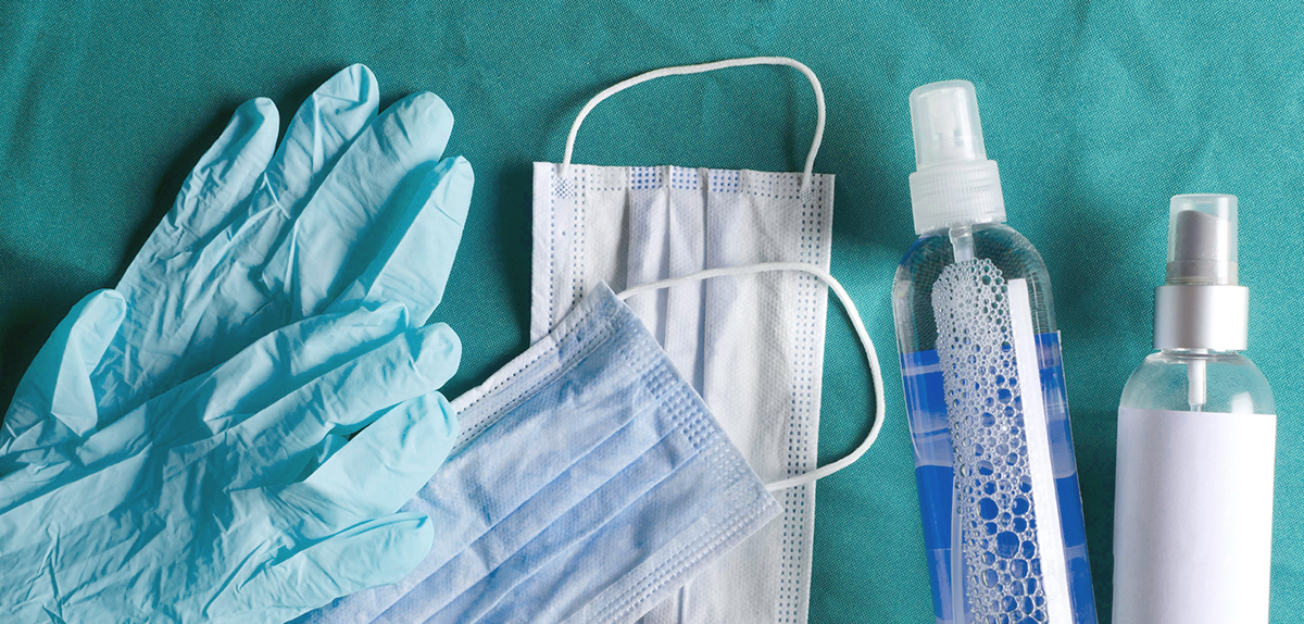 A photograph of surgical gloves, masks, and sanitizers